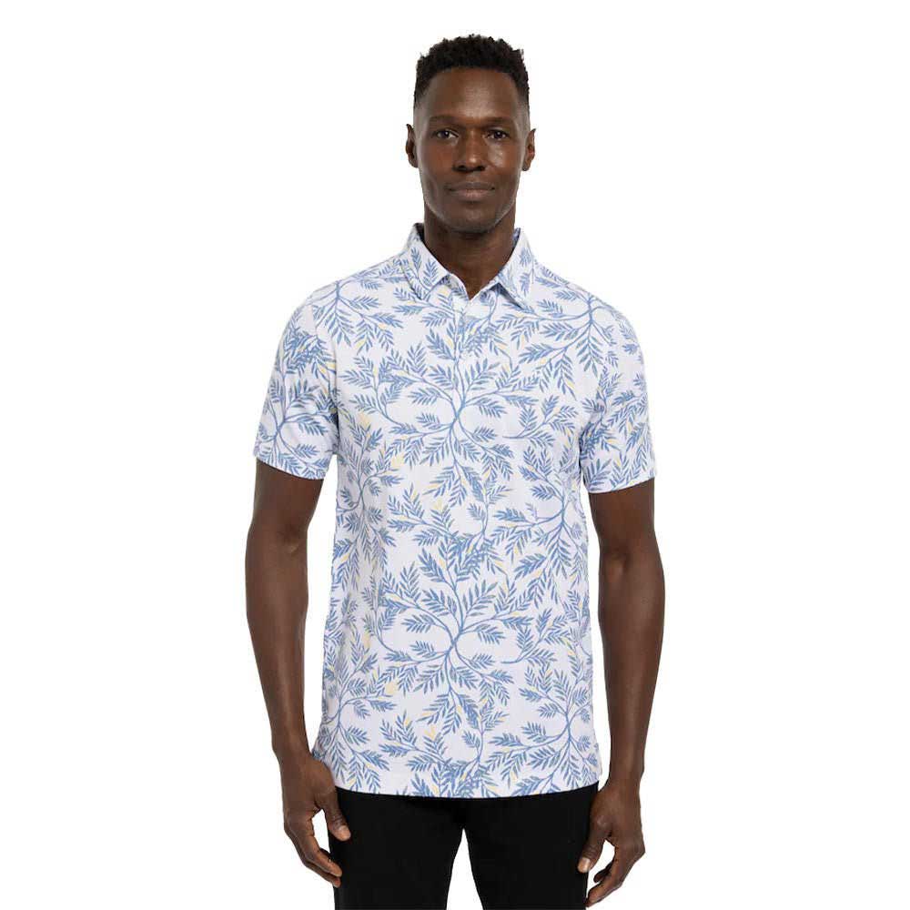 Man wearing a Travis Mathew Desert Wind Men's Golf Polo Shirt
in white with blue floral print.