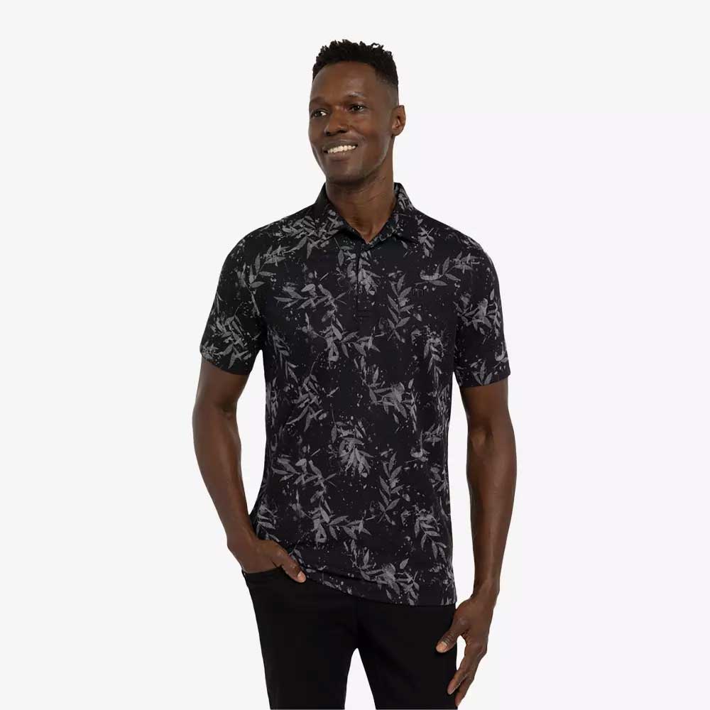 Man wearing a Travis Mathew The Riegel Men's Golf Polo Shirt in Black