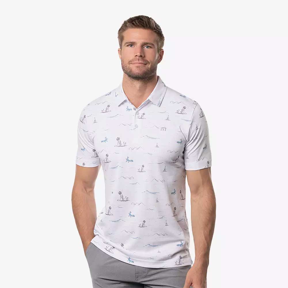 Man wearing a Travis Mathew Warp Drive Polo Shirt in White