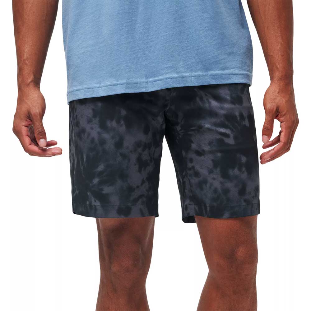 Man wearing Travis Mathew Men's Kapu Black Golf Shorts