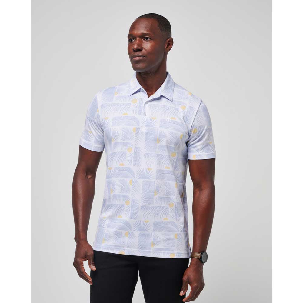 Man wearing a white Travis Mathew Sun Guilt Men's Polo Shirt.