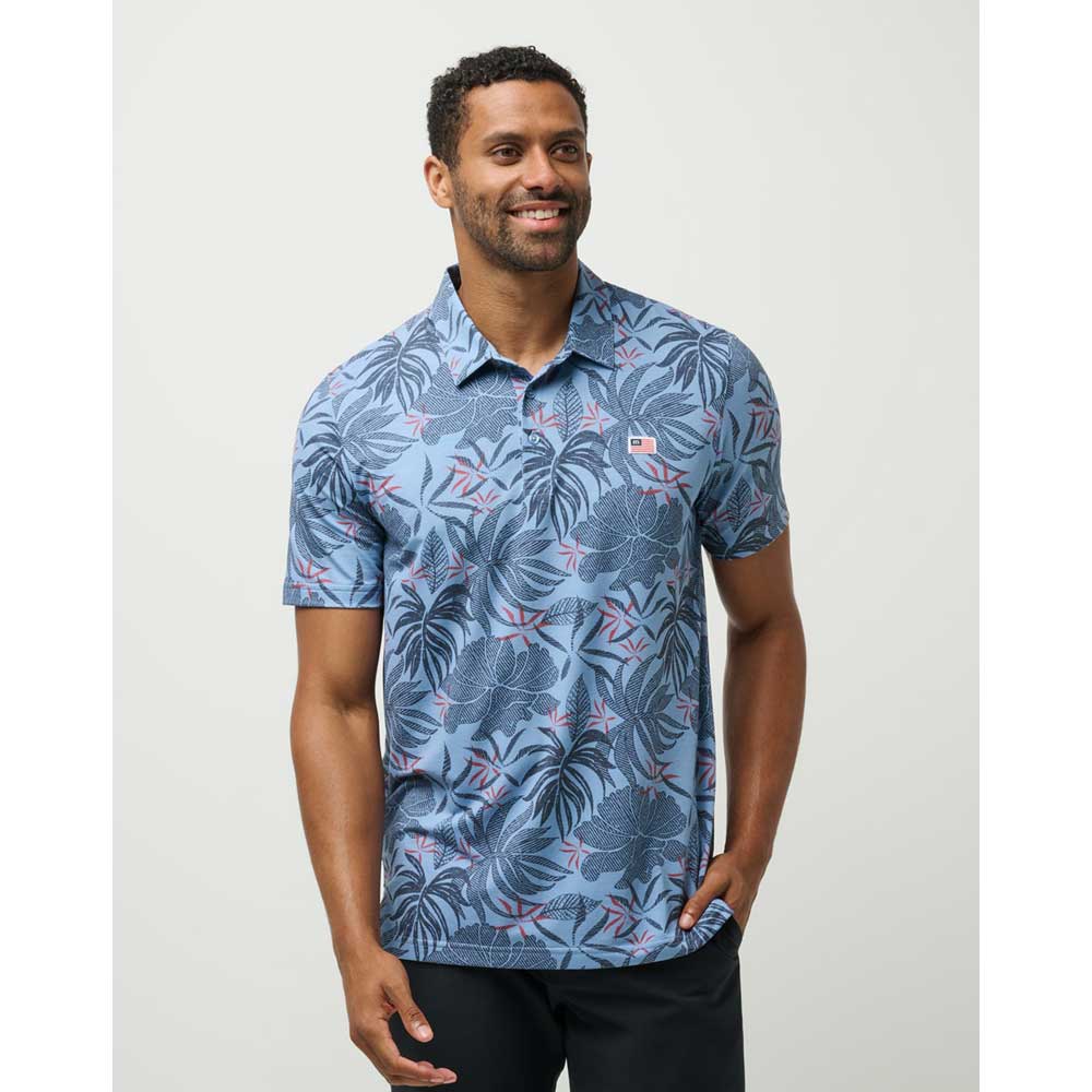 Man wearing Travis Mathew Red Letter Day Patriotic Floral Men's Polo Shirt 